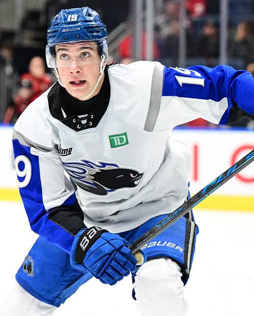 Hockey prospect skating in white and blue